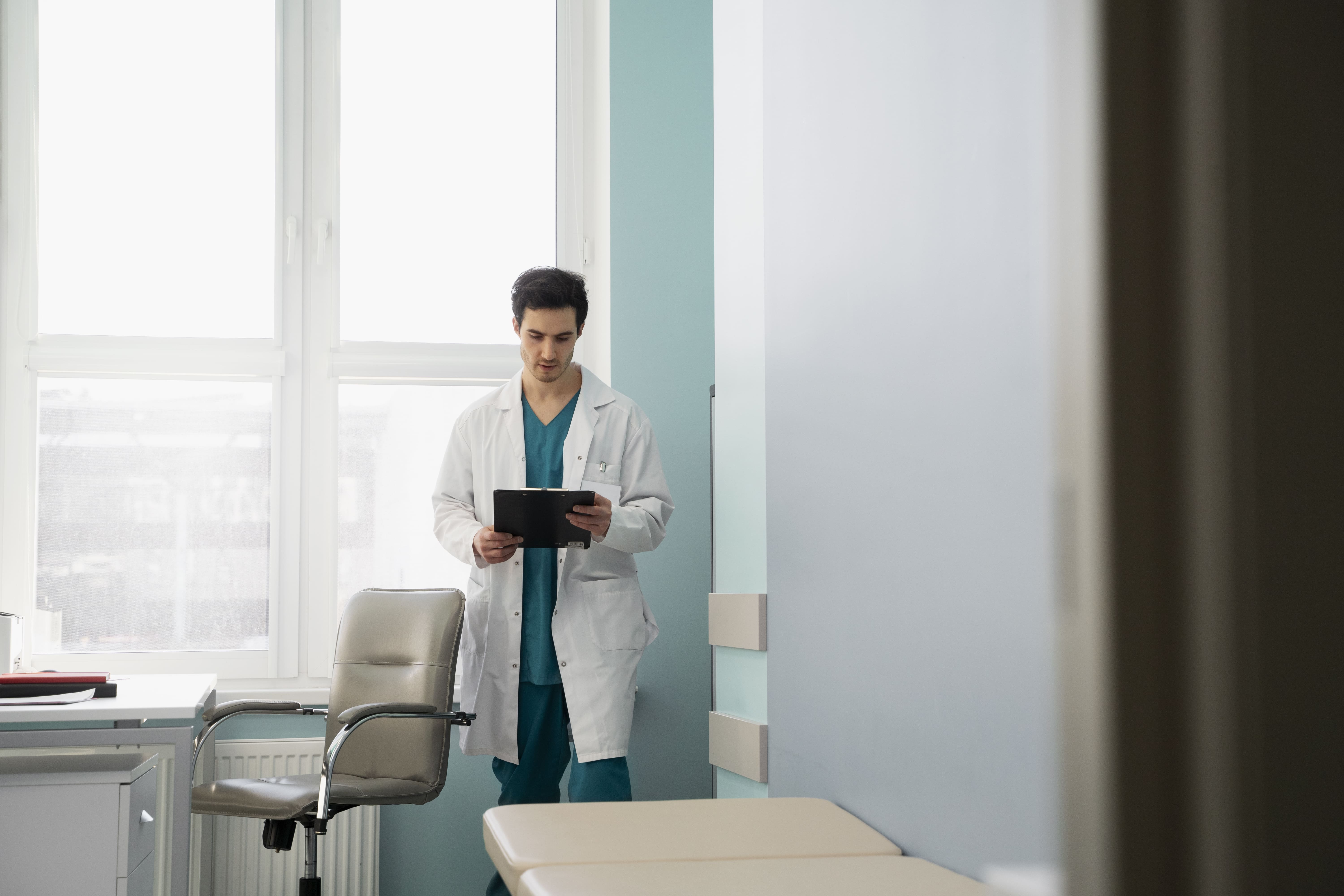 full-shot-doctor-holding-document (1).jpg